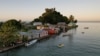 FILE - The morning's first rays of sunlight hit the island community of Serua Village, Fiji, July 15, 2022. Rising sea levels are a growing threat to such island villages. 