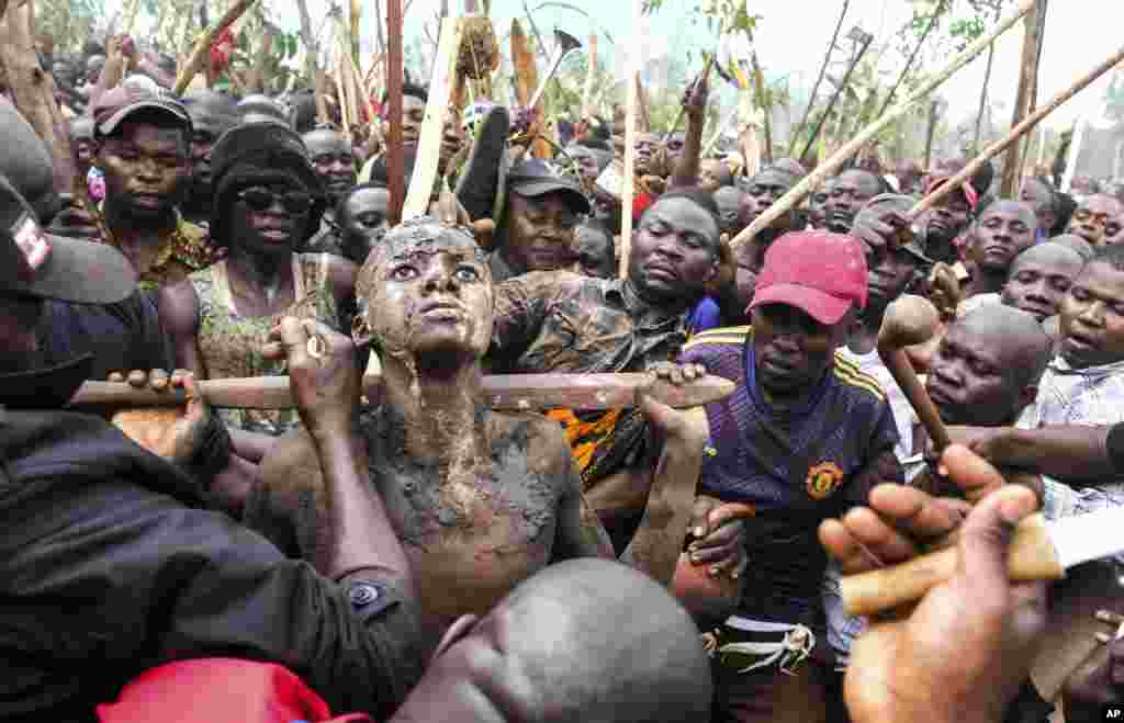 Daniel Wabuyi reacts during his traditional circumcision ritual, known as Imbalu, at Kamu village in Mbale, Eastern Uganda,.