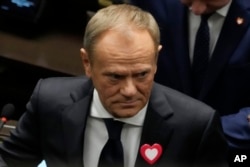 The leader of Poland's opposition alliance, Donald Tusk, attends the first session of the lower house, or Sejm, of the newly-elected parliament in Warsaw, Poland, Nov. 13, 2023.