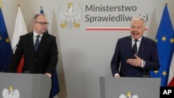 European Commissioner for Justice, Didier Reynders, right, and Poland's new Justice Minister Adam Bodnar take part in a news conference, in Warsaw, Poland, Jan. 19, 2024.