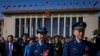 Military officers and delegates leave the Great Hall of the People after attending the second plenary session of the National People's Congress (NPC) in Beijing, March 8, 2024.