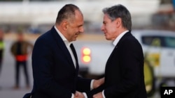 Greek Foreign Minister George Gerapetritis, left, greets U.S. Secretary of State Antony Blinken, as he arrives on the island of Crete, Greece, Jan. 6, 2024, during Blinken's latest trip to the Middle East. (Evelyn Hockstein/Pool Photo via AP)