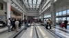 People stand near their luggage at the Beirut-Rafic Al Hariri International Airport, in Beirut, Lebanon, Aug. 4, 2024.