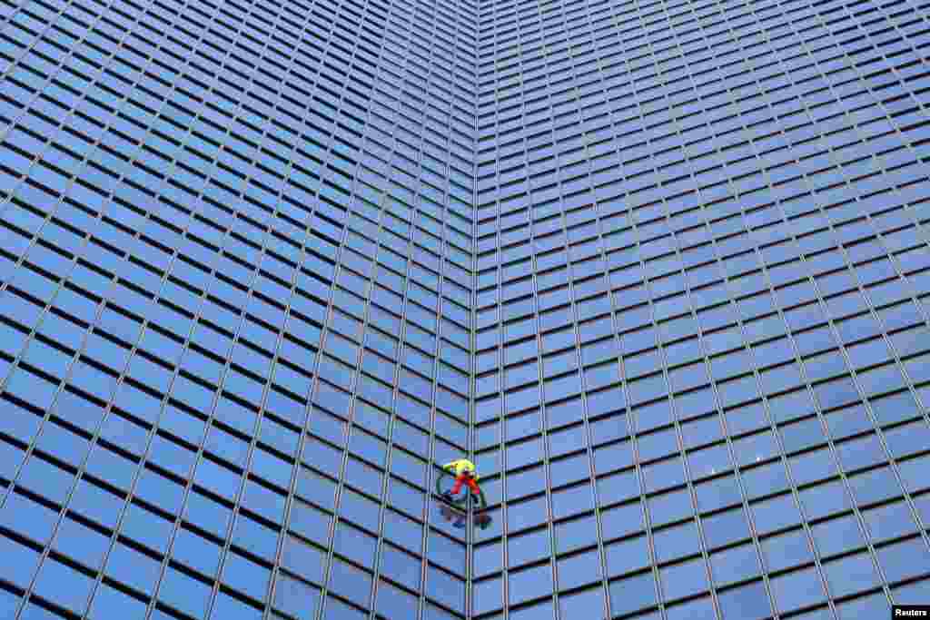 French skyscraper climber Alain Robert climbs the Tour TotalEnergies Coupole skyscraper to call for &quot;Peace in the Middle East&quot; in Puteaux at the financial and business district of La Defense, in Puteaux, near Paris, France. REUTERS/Abdul Saboor