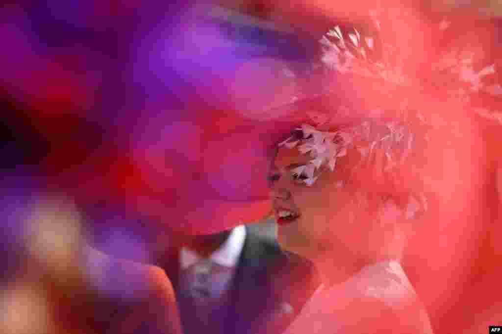 A racegoer smiles in the summer sunshine on Ladies Day, the third day of the Royal Ascot horse racing meeting in Ascot, west of London.