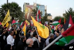 Iranian protesters wave Iranian, Palestinian and Hezbollah flags in a demonstration to condemn the killing of Hamas leader Ismail Haniyeh, at Felestin (Palestine) Square in Tehran, Iran, July 31, 2024.