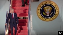U.S. President Joe Biden walks down the steps of Air Force One as he arrives at Stansted Airport in Stansted, England, July 9, 2023.