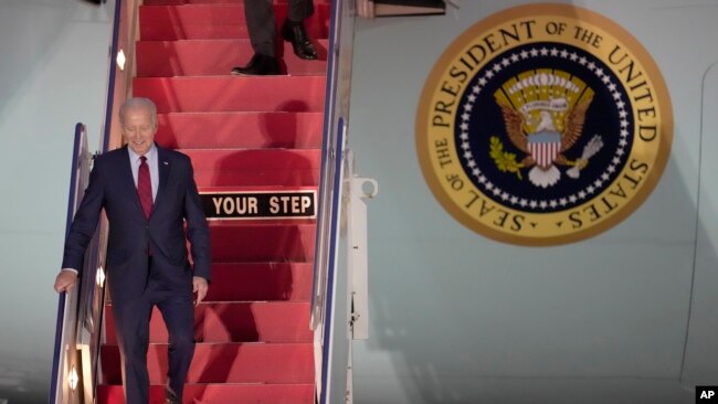 U.S. President Joe Biden walks down the steps of Air Force One as he arrives at Stansted Airport in Stansted, England, July 9, 2023.