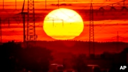 FILE - The sun rises above a highway in Frankfurt, Germany, Aug. 2, 2022. 