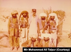 Mir Muhammad Ali Talpur stands third from left with Marri tribesmen in Lashkargah, Afghanistan, in 1985.