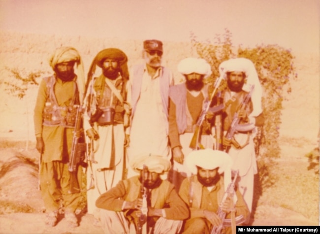 Mir Muhammad Ali Talpur stands third from left with Marri tribesmen in Lashkargah, Afghanistan, in 1985.