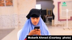 FILE - Photo of a young girl using the Daariz app in the Sahamiye Foundation's speed-reading competition in Galkacyo, Somalia, summer 2022. 