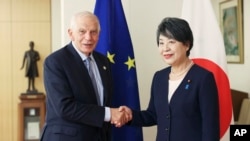 The European Union foreign policy chief Josep Borrell shakes hands with Japanese Foreign Minister Yoko Kamikawa as they pose for the cameras during their bilateral meeting at the foreign ministry in Tokyo, Nov. 8, 2023.