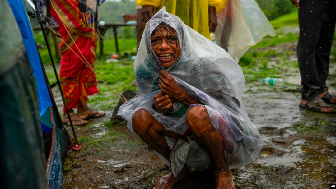 A woman whose family members are trapped under rubble wails after a landslide washed away houses in Raigad district, western Maharashtra state, India, July 20, 2023. 