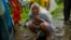 A woman whose family members are trapped under rubble wails after a landslide washed away houses in Raigad district, western Maharashtra state, India, July 20, 2023. 