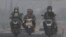 Riders wear masks as they pass through the haze from forest fires in Palembang, South Sumatra, Indonesia, Oct. 6, 2023.