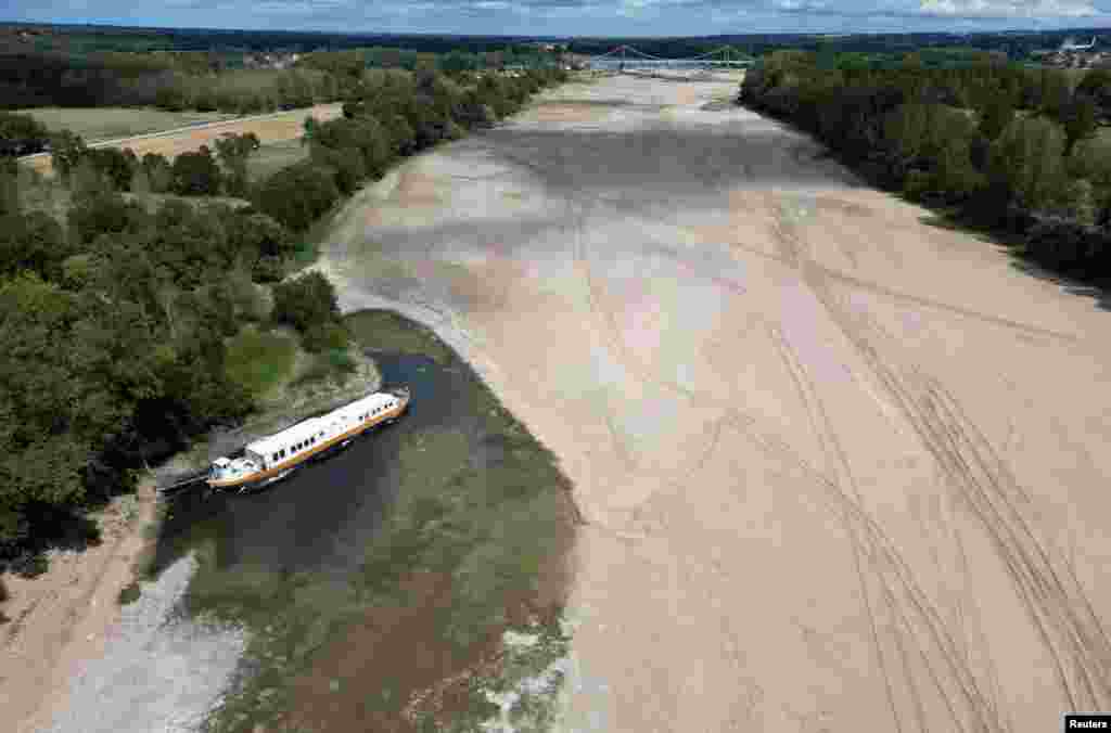 n aerial view shows a barge moored along the banks of a branch of the Loire River, in Loireauxence, France.