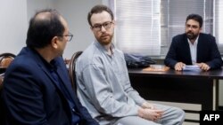 FILE - Swedish EU diplomat Johan Floderus, center, attends a court session in Tehran on Dec. 10, 2023. The Swede, who works for the EU diplomatic service, was arrested on Apr. 17, 2022, at Tehran airport as he was returning home from a trip with friends.