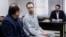 FILE - Swedish EU diplomat Johan Floderus, center, attends a court session in Tehran on Dec. 10, 2023. The Swede, who works for the EU diplomatic service, was arrested on Apr. 17, 2022, at Tehran airport as he was returning home from a trip with friends.