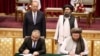 Uzbek Prime Minister Abdulla Aripov, back row, left, and Taliban Deputy Prime Minister for Economic Affairs Mullah Abdul Ghani Baradar, back row, right, oversee the signing of Memorandums of Understanding in Kabul, Afghanistan, Aug. 17, 2024. 