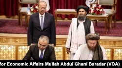 Uzbek Prime Minister Abdulla Aripov, back row, left, and Taliban Deputy Prime Minister for Economic Affairs Mullah Abdul Ghani Baradar, back row, right, oversee the signing of Memorandums of Understanding in Kabul, Afghanistan, Aug. 17, 2024. 