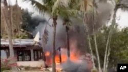 This frame grab from video shows fire coming from a plane that crashed by a home in Vinhedo, Sao Paulo state, Brazil, Aug. 9, 2024.