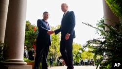 U.S. President Joe Biden, right, greets China's President Xi Jinping at the Filoli Estate in Woodside, California, on the sidelines of the Asia-Pacific Economic Cooperation leaders' week, Nov. 15, 2023. (Doug Mills/The New York Times via AP, Pool)