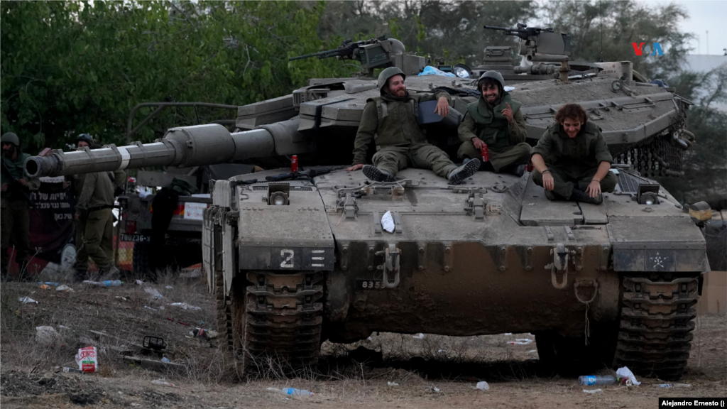 Soldados de las Fuerzas de Defensa de Israel descansan encima de un tanque en las cercanías del kibutz Be&#39;eri, una comuna donde Hamás asesinó a más de 100 habitantes y recuperada por el ejército israelí, que mantiene una fuerte presencia en el lugar, el 11 de octubre de 2023.