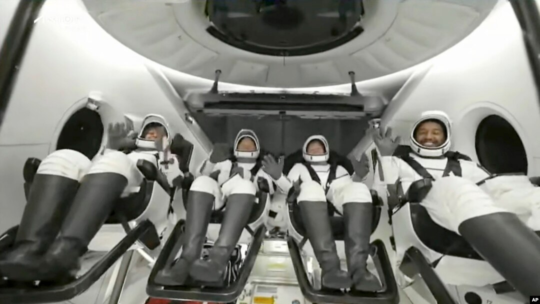 In this image taken from video broadcast by SpaceX, crew members wave after the SpaceX Dragon capsule splashed down into the Gulf of Mexico, just off the Florida Panhandle, May 30, 2023. (SpaceX via AP)