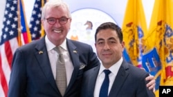 George Helmy, right, is pictured next to New Jersey Governor Phil Murphy after it was announced that he would take the U.S. Senate soon to be vacated by Senator Bob Menendez, in Newark, N.J., Aug. 16, 2024.