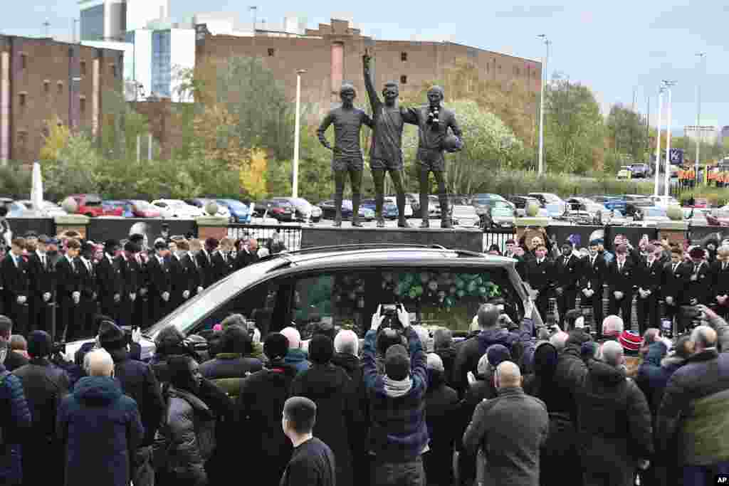 The cortege of English soccer icon Bobby Charlton passes by the statue of Manchester United trio of George Best, left, Denis Law, center, and Sir Bobby Charlton outside Old Trafford stadium&nbsp;on its way to the funeral service at Manchester Cathedral&nbsp;in Manchester, England.