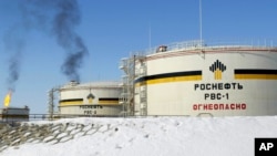 FILE - Reservoirs seen at Priobskoye oil field near Nefteyugansk, in western Siberia, Russia, on April 5, 2006. 