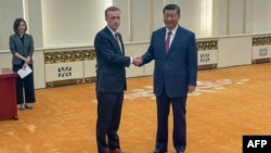 White House national security adviser Jake Sullivan, left-center, shakes hands with China's President Xi Jinping during their meeting at the Great Hall of the People in Beijing, Aug. 29, 2024.