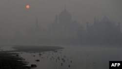 The Taj Mahal is seen amid heavy smog as the sun rises in Agra, India, on Nov. 9, 2023.