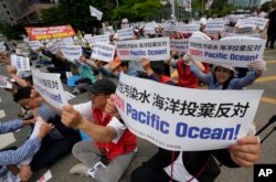 South Korean fishermen stage a rally against the planned release of treated radioactive water from the wrecked Fukushima nuclear power plant, in front of the National Assembly in Seoul, South Korea, Monday, June 12, 2023. (AP Photo/Ahn Young-joon)