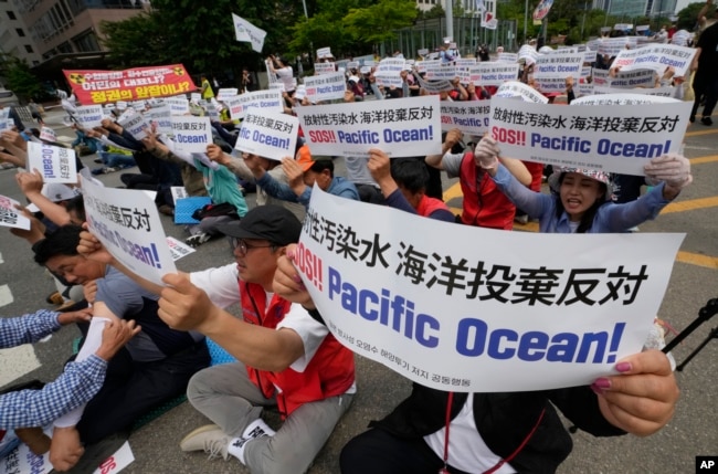 South Korean fishermen stage a rally against the planned release of treated radioactive water from the wrecked Fukushima nuclear power plant, in front of the National Assembly in Seoul, South Korea, Monday, June 12, 2023. (AP Photo/Ahn Young-joon)