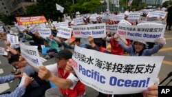 South Korean fishermen stage a rally against the planned release of treated radioactive water from the wrecked Fukushima nuclear power plant, in front of the National Assembly in Seoul, South Korea, Monday, June 12, 2023. (AP Photo/Ahn Young-joon)