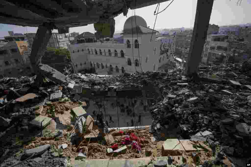 Palestinians look at a damaged residential building after an Israeli strike in Rafah, southern Gaza Strip.