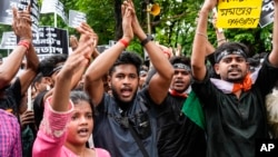 Activists shout slogans as they join a rally protesting the rape and murder of a resident doctor at a government hospital earlier this month, in Kolkata, India, Aug. 27, 2024.