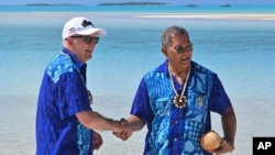 Australia's Prime Minister Anthony Albanese, left, and Tuvalu's Prime Minister Kausea shake hands on One Foot Island after attending the Leaders' Retreat during the Pacific Islands Forum in Aitutaki, Cook Islands, Nov. 9, 2023.