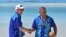 Australia's Prime Minister Anthony Albanese, left, and Tuvalu's Prime Minister Kausea shake hands on One Foot Island after attending the Leaders' Retreat during the Pacific Islands Forum in Aitutaki, Cook Islands, Nov. 9, 2023.