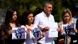 Lebanese journalists hold portraits of Reuters videographer Issam Abdallah, who was killed by Israeli shelling, during a protest in front of the United Nations headquarters in Beirut, Oct. 15, 2023.