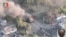 A tank burns as Ukrainian Armed Forces members liberate the town of Staromaiorske, in the Donestk region, Ukraine, in this still image obtained from video social media and released July 27, 2023. (35th Separate Marines Brigade of the Ukrainian Armed Forces/via Reuters)