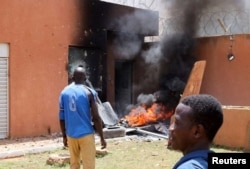 Pro-coup demonstrators are seen outside the French embassy, trying to set it on fire, before being dispersed by Nigerien security forces in Niamey, Niger, July 30, 2023.