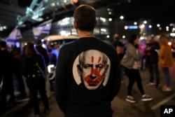 A protester — who wears a shirt bearing an image of Israeli Prime Minister Benjamin Netanyahu — stands at a Tel Aviv, Israel, demonstration demanding the release of the hostages kidnapped on October 7 by Hamas militants, Jan. 20, 2024.