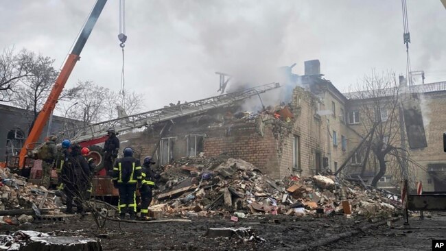 In this photo provided by Ihor Moroz, Head of the Donetsk Regional Military Administration, rescuers work at the scene of a building destroyed by shelling, in Novohorodivka, Donetsk region, Ukraine, Nov. 30, 2023.