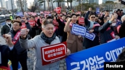 South Korean doctors take part in a protest against the government medical policy in front of the presidential office in Seoul, South Korea, Feb. 25, 2024. 