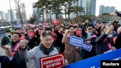 FILE - South Korean doctors take part in a protest against the government medical policy in front of the presidential office in Seoul, South Korea, Feb. 25, 2024.