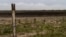 FILE - A water meter stands in a dry wetland in Donana natural park, southwest Spain, on Oct. 19, 2022. 