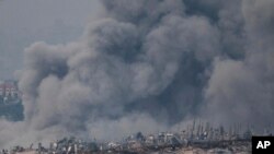 FILE - Smoke rises following an Israeli bombardment in the Gaza Strip, as seen from southern Israel on Thursday, December 7, 2023.
